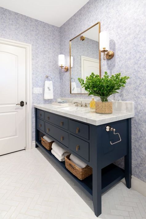 A classic color like navy is perfect for any space. Navy Vanity Bathroom Ideas, Navy Vanity, White Glass Tile, Navy Bathroom, Blue Floral Wallpaper, Blue Vanity, Blue Ceilings, Floral Bathroom, Master Bath Remodel