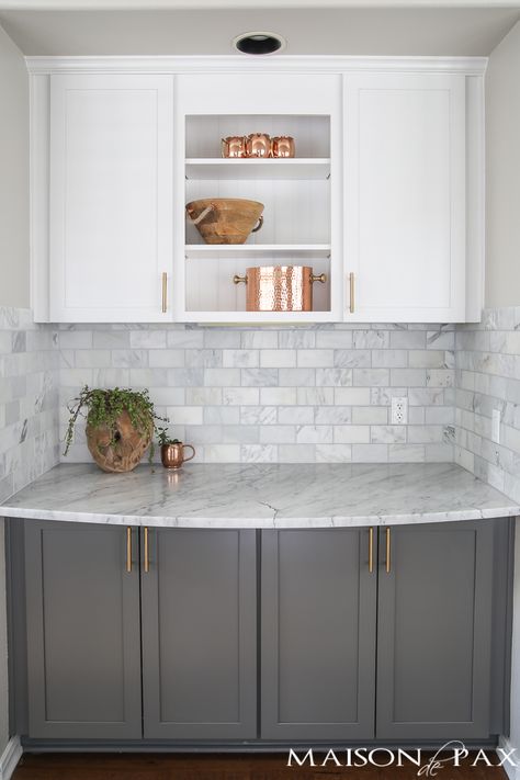 Two-toned gray and white cabinets, marble subway tile, Carrara countertops, a big farmhouse sink, and brass hardware give this kitchen a classic yet modern look. Gray And White Cabinets, Big Farmhouse, Modern Farmhouse Kitchen Cabinets, Marble Subway Tile, White Marble Kitchen, Серая Кухня, Interior Dapur, Kitchen Ikea, Gray And White Kitchen