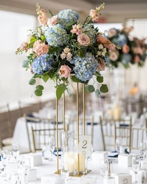 Remembering these beautiful centerpieces by @withallmyheartfloral for Samantha and William’s wedding this past June. 💍 💕 🌸 Bride: @samgambardella Photography: @lighthousephotographyweddings Venue: @thepiermont #withallmyheartfloral #highcenterpiece #floralinspo #bridesoflongisland #boli #floralinspo #liflorist #wedding #weddingwednesday #weddinginspiration #weddingvenue #engaged #bride #groom #bridetobe #brides #longislandwedding Peach And Blue Wedding Flowers, Tall Gold Vase, Peach And Blue Wedding, Flower Centerpiece Wedding, Tall Gold Vases, June Bride, Gold Vase, Flower Centerpiece, Centerpiece Wedding