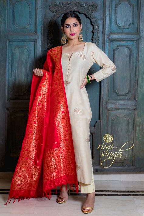 Muga silk kurta with lotus motifs paired with a cotton lycra pants in its natural colour. It is teamed with a red  katan silk dupatta. Brocade Dupatta Suits, White Kurta With Colourful Dupatta, Red Embroidery On White Suit, White Anarkali Dress With Red Dupatta, White Suit With Red Dupatta, White Suit With Coloured Dupatta, Bride Trousseau, Formal Kurti, Long Kurti Patterns