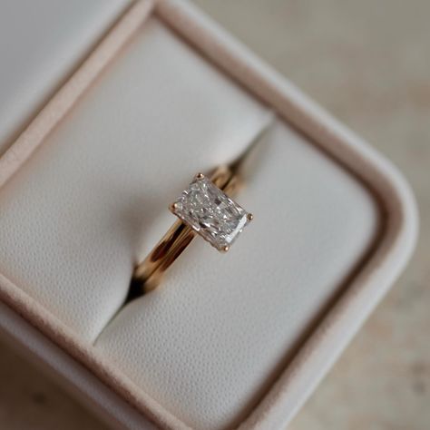 A beautifully elongated radiant cut diamond, with a hidden halo and matching plain wedding band to complete the look ✨ Details: - 2ct radiant diamond - 18x round diamonds for hidden halo - 18k yellow gold - 1.8mm wide shank (for both engagement ring and wedding band) #radiantengagementring #radiantcutdiamond #nz #hiddenhalo #aus #customengagementring Elongated Radiant Cut, Elongated Radiant, Radiant Diamond Engagement Rings, Radiant Engagement, Engagement Ring And Wedding Band, Radiant Cut Engagement Rings, Plain Wedding Band, Radiant Engagement Rings, Classic Engagement