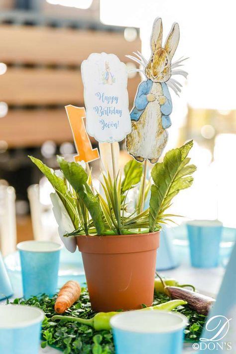 Some Bunny is One | CatchMyParty.com Peter Rabbit Party Centerpieces, Flopsy Rabbit Birthday Party, Peter Rabbit Centerpieces, Peter Rabbit Centerpiece, Bunny First Birthday Boy, Some Bunny Is One Boy, Peter Rabbit Centerpiece Ideas, Flopsy Bunny 1st Birthday, Rabbit Baby Shower Ideas