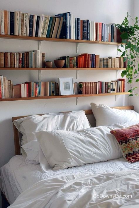 Headboards occupy a ton of space, so we better find ways to maximize this area of our bedroom. Books Over Bed, Book Display Ideas Home Bedroom, Floating Bookshelves Above Bed, Book Shelves Above Bed, Books Above Bed, Bookshelves Over Bed, Book Shelf Above Bed, Bookshelf Over Bed, Bookshelves With Plants