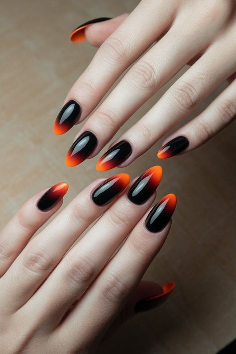 The photo shows a hand with medium-length nails painted in a bold orange and black ombré design. Black And Orange Nail Designs, Orange And Black Nail Designs, Orange And Black Nails, Edgy Nail Art, Pastel Blue Nails, Orange Nail Designs, Ten Nails, Square Nail Designs, Green Nail Designs