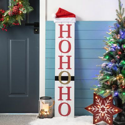 Crafted from textured MDF, this Christmas sign features a lambswool hat on the top of the sign. On one side is a smiling snowman with a Welcome printed on its body. The other side is the Santa belt with HoHoHo. Stylish design with classical red and black, it brings a traditional and classic feel to your holiday home. | The Holiday Aisle® Junno Reversible Wooden Christmas Snowman Porch Sign 42.5 H x 8.25 W x 2.25 D in black / brown / red / whiteWood in Black / Red | 42.5" H X 8.25" W X 2.25" D | Christmas Signs Wood Front Porches, Santa Belt, Wooden Sleigh, Christmas Wooden Signs, Snowman Sign, Wooden Porch, Wooden Welcome Signs, Front Porch Signs, Christmas Signs Wood