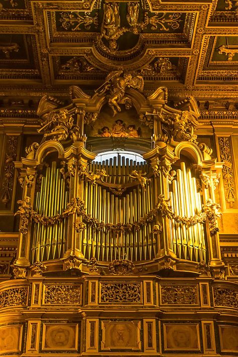 San Giuseppe dei Falegnami, Rome. The large wooden bow-fronted organ gallery, which is corbelled out and occupies the entire width of the nave. The actual organ case is a spectacularly intricate piece of Baroque design featuring carved angels blowing trumpets. Just above the pipes is a fresco of an angelic musical trio. Baroque Music, Pipe Organ, Sacred Architecture, Wooden Bow, Baroque Design, Magic Hour, Trumpets, Rome, Carving