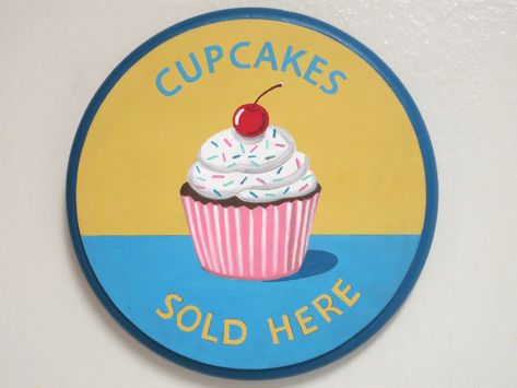 "This round painted wood cupcake sign will look adorable in anyone's kitchen. It's a fun sign stating, \"Cupcakes Sold Here\". It's blue and gold with the cutest cherry topped cupcake. I have painted it with acrylic paint and sealed it with a clear finish so it can be lightly wiped clean. It is made out of wood that is 3/4 of an inch thick. The sign measures 6 1/2 inches in diameter and I have added a sawtooth hanger on the back. My signature is at the bottom. Makes a great gift for anyone who l Cupcakes For Sale, Cupcake Sign, Fun Kitchen Decor, Cupcake Signs, In Law House, Fun Sign, Sale Sign, Fun Kitchen, Summer Craft