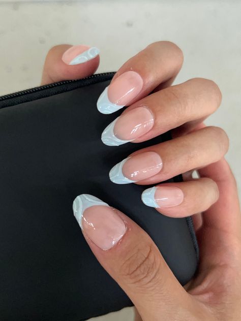 Special Offer: Enjoy free shipping on orders of $55 or more with the code: FREESHIP55. This collection features a variety of nail styles to suit your personal taste, including  Coffin and Oval. The model is showcasing our Oval-shaped nails, adorned with delicate blue patterns that evoke the calming essence of the ocean breeze. Each pair of nails in this collection is meticulously crafted by skilled manicurists, ensuring that every set is unique. As these designs are handmade, they may feature slight imperfections, adding a touch of individuality and character to your look. Pale Blue Nails French Tip, Cute Oval Nails Ideas, French Tips Teal, French Nails Oval Shape, Nail Art French Tip Designs, Acrylic Nails Designs Unique, Oval Nails French Tip, Swirl French Tip Nails, Simple Nails Coffin