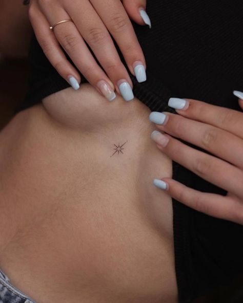 Minimalistic style north star tattoo done on the North Star Back Tattoo, Dainty Rib Cage Tattoos For Women, Northern Stars Tattoo, Small Dainty Women’s Tattoos, Sun Tattoo In Between Chest, Minimalist Guy Tattoo, One Star Tattoo, North Star Tattoo Sternum, Dainty Saturn Tattoo