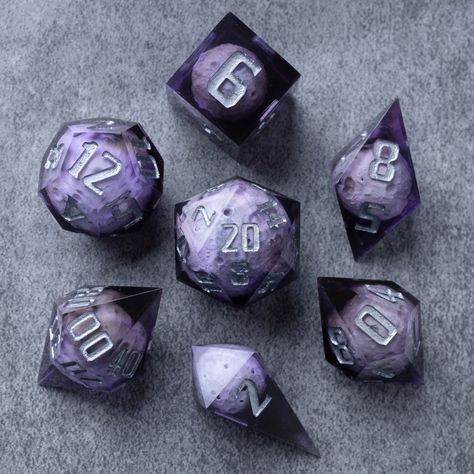 The full set will come with D4 D6 D8 D10 D% D12 D20. The asteroids are made out of resin, the same material as the clear portion of the dice, and remains balanced. For use with DnD, Pathfinder, and other TTRPG systems. Asteroid dice set comes in a custom-made velvet pouch and wooden box, providing convenient storage and portability. Take them with you to gaming sessions, conventions, or unleash them upon your gaming table, instantly transforming your gaming space into an enchanting realm of adve Dnd Aesthetic Dice, Dice Ideas, Cool Dnd Dice, Pretty Dice, Dice Goblin, Gaming Space, Dnd Dice Set, Gaming Table, Dungeons And Dragons Dice