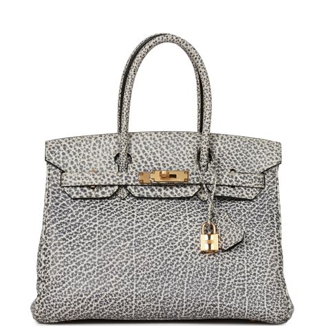 This rare Vintage Birkin is in White dalmatian buffalo leather with gold hardware and has tonal stitching, a front toggle closure, a clochette with lock and two keys, and double rolled handles.The interior is lined with black leather and has one zip pocket with an Hermes engraved zipper pull and an open pocket on the opposite side. Collection: E squareOrigin: FranceCondition: Vintage; Excellent to Mint - The bag retains its structure. The leather is clean with minimal signs of wear. The hardware has plastic with light scratching visible upon close inspection. The interior is clean with light signs of prior use.Accompanied by: Hermes box, Hermes dustbag, clochette, lock, two keys, clochette dustbag, carebookMeasurements: 11.75" width x 9.5" height x 6" depth; 4.25" handle drop White Birkin Bag, Celeb Lifestyle, Vintage Birkin, Birkin Collection, Basic Bags, Rare Hermes Birkin, Celebrity Bags, Birkin 30, Hermes Birkin 25