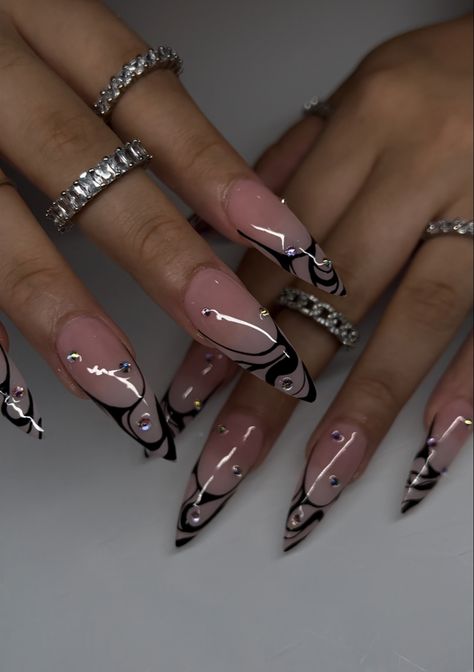 Stiletto gel x nails with pink base and black swirl French tip with crystals scattered Black Almond Acrylic Nails Design, Almond Nails Designs Medium Length, Black Acrylic Nails Black Women, Black Designed Nails, Trendy Nail Inspo Winter, Gothic Style Nails, Clear Nails With Black Designs, Concert Nails Black, Over The Top Nail Designs