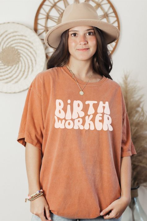 Birth Worker, Doula Gift, Doula Shirt, Midwife Student, Love What you Doula, Talk Birthy This classic unisex jersey short sleeve tee fits like a well-loved favorite. Soft cotton and quality print make users fall in love with it over and over again. These t-shirts have-ribbed knit collars to bolster shaping. The shoulders have taping for better fit over time. Dual side seams hold the garment's shape for longer. 100% Airlume combed and ringspun cotton Care Instructions: Turn inside out and machine wash on cold gentle cycle. Use a mild detergent and wash with like colors. Do not use fabric softeners or dry clean. Tumbler dry on low or, even better, hang to dry. If needed, turn garment inside our and cool iron the shirt, avoiding ironing directly over the print. Return policy: Every T-shirt is Doula T Shirt, Doula Aesthetic, Doula Shirt, Birth Worker, Doula Gifts, Student Midwife, Thank You Nurses, Midwife Gift, Nurse Gifts