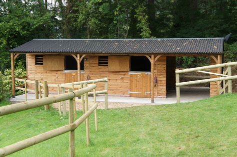 This stable block includes two 3.6m x 3.6m stables, a 3m x 3.6m covered walkway and a small store to the rear. The following optional extras were added – the overhang has been extended to 1.5m, which includes the support posts and curved angle braces, the overhang has been lined with plywood.   All available as optional extras. Small Stable, Small Horse Barns, Stable Block, Horse Barn Ideas Stables, Small Barns, Shingle Roof, Horse Barn Designs, Horse Shelter, Dream Horse Barns