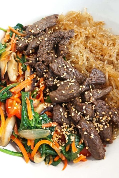 Savory, noodly, and saucy! This low carb / keto version of japchae includes soft kelp noodles, fresh veggies and marinated ribeye steak. It's a hearty bowl of low-carb goodness! ModernYum.com #modernyum #keto #lowcarb #lchf #japchae #koreanfood #ketokorean #ketokoreanfood #kelpnoodles #ketopasta #ketonoodles #ketostirfry Glass Noodle Stir Fry, Chicken And Veggie Recipes, Glass Noodles Recipe, Keto Stir Fry, Korean Glass Noodles, Keto Noodles, Kelp Noodles, Noodle Stir Fry, Beef Marinade