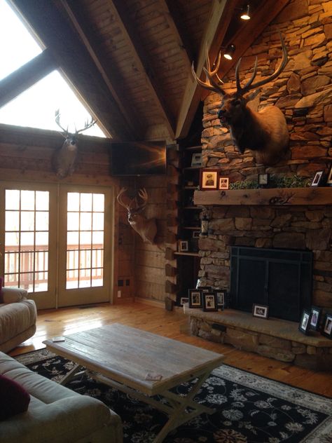 Rustic living room. Hunting trophies. Elk mount. Log cabin living room Elk Above Fireplace, Moose Mount Living Room, Hunting Camp Ideas Cabin Living Room, Deer On Wall Living Room, Deer Head In Living Room, Deer Cabin Decor, Hunting Cabin Aesthetic, Taxidermy Living Room, Elk Mount Living Room