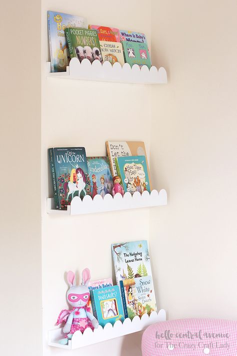 Add some scalloped trim to your boring book ledges to give them a fresh new upgrade!  The scalloped book ledges will give your space a fun and whimsical feeling! #shelfie #bookledges #bookshelves #TheCrazyCraftLady Scalloped Shelf Nursery, Scalloped Book Ledge, Scallop Book Ledge, Scallop Shelves Nursery, Book Shelf Ideas For Nursery, Girl Bedroom Shelves, Children Book Shelf, Scalloped Wall Shelf, Diy Scalloped Bookshelf