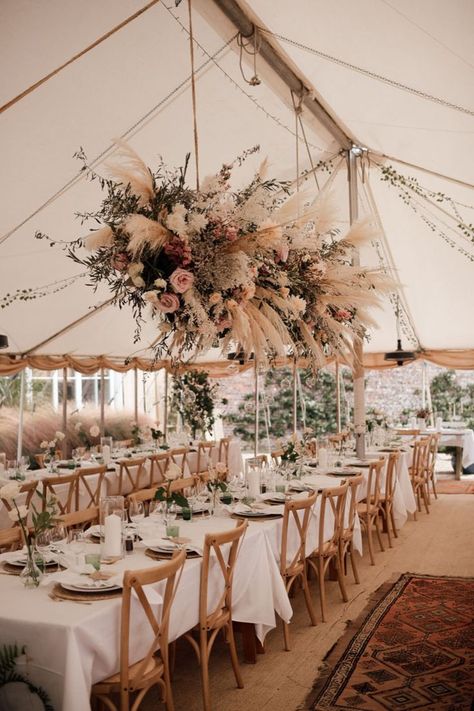 White marquee wedding with banquet tables with wooden chairs and white tablecloths and large flower installation with pampas grass and pink roses Marquee Wedding Decoration, Tipi Wedding Decor, Humanist Wedding Ceremony, Marquee Decoration, Riverside Weddings, Field Wedding, Country Garden Weddings, Grass Wedding, Flower Installation