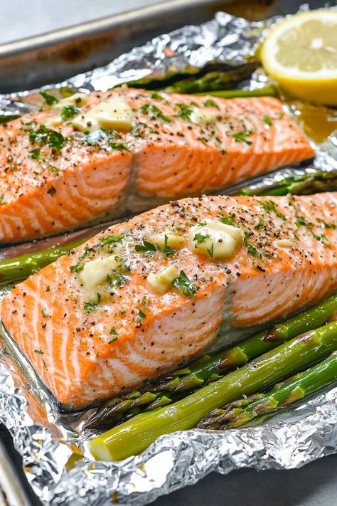 Discover the perfect weeknight dinner idea with this easy recipe for baked salmon and asparagus in foil. This dish is not only delicious but also quick to prepare, making it ideal for busy evenings when you want a healthy meal without all the fuss. The combination of tender salmon, flavorful asparagus, and zesty seasonings all cooked together in a foil packet creates a mouthwatering meal that will impress your family and friends. Salmon Foil Packets Oven Asparagus, Salmon With Asparagus In Foil, Salmon Asparagus Pasta Recipes, Oven Baked Salmon And Asparagus, Foil Packet Salmon Oven, Salmon And Asparagus Recipes, Salmon Foil Packets Oven, Salmon And Asparagus In Foil, Salmon Asparagus Foil