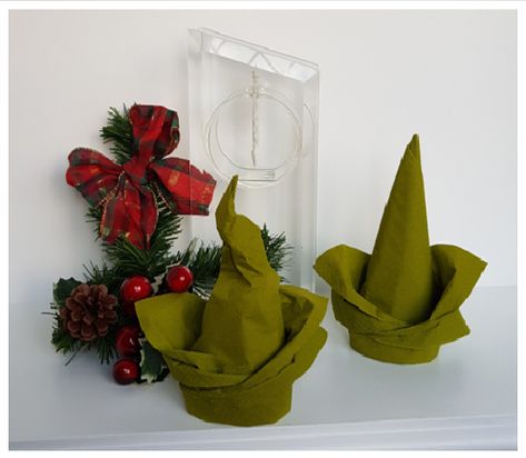 These are easy to fold and you can be a little creative about the end result.  Lovely for Christmas but might even work for Halloween if you form that out of black napkins. Elf Hat Napkin Folding, Halloween Napkins Folding, Halloween Napkin Folding Ideas, Halloween Napkin Folding, Diy Napkin Folding, Christmas Elf Hat, Napkin Folding Tutorial, Christmas Napkin Folding, Napkin Art