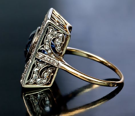 An Unusual Antique Sapphire and Diamond Engagement Ring circa 1900 The rectangular silver topped 18K gold ring is centered with an egg-shaped faceted natur Bijoux Art Nouveau, The Bling Ring, Diamond Gold Ring, Vintage Style Rings, Faberge Eggs, Cluster Rings, Tiffany Jewelry, Sapphire Diamond Ring, Deco Jewelry