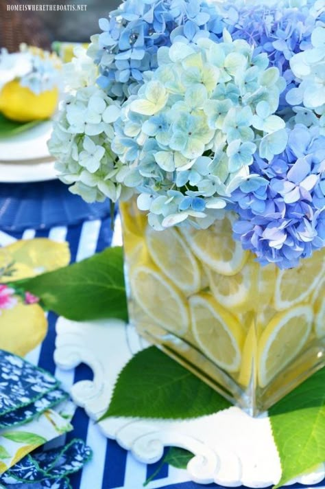 When life or a trip to the grocery store gives you lemons, make an easy table centerpiece, no floral arranging skills required! I'm always looking for an easy table centerpiece and this bag of $4.99 lemons at the grocery store provided some sunny and affordable table inspiration. I used my favorite ‘vase within a vase’ method for flower arranging and a centerpiece for the table. Start with two vases, a smaller one to nest inside a larger one. They can be any shape or size, as long… Lemon Vase, Lemon Centerpieces, Lemon Themed Bridal Shower, Wood Dough Bowl, Lemon Seeds, Endless Summer Hydrangea, Backyard Bbq Party, Fun Backyard, Easy Table