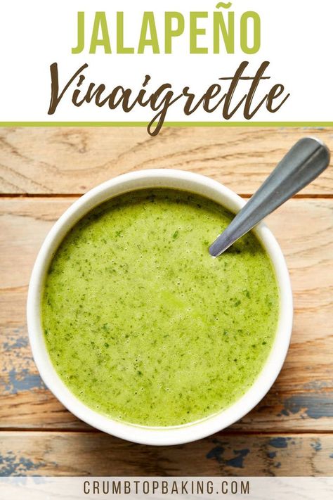 Jalapeño vinaigrette in a small bowl with a spoon inserted into it. Jalapeno Lime Dressing, Jalapeño Lime Dressing, Cilantro Juice, Jalapeno Dressing, Cilantro Jalapeño Vinaigrette, Lime Cilantro Jalapeno Vinaigrette, Cilantro Jalapeno Dressing, Jalapeño Dressing, Cilantro Lime Dressing Vinaigrette