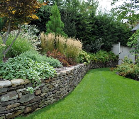 Dry laid Pennsylvania field stone wall. Field Stone Wall, Natural Stone Retaining Wall, Stone Walls Garden, Elegant Landscape, Landscaping Around House, Garden Retaining Wall, Sloped Backyard, Stone Retaining Wall, Landscaping Retaining Walls