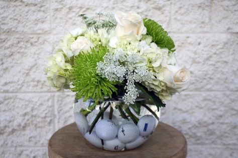 Golf balls!? Yup! - Four Seasons Flowers Centerpiece Golf Ball Flower Arrangements, Golf Themed Centerpieces Flower, Golf Wedding Centerpieces, Golf Ball Centerpieces, Golf Birthday Centerpieces, Golf Outing Centerpieces, Golf Party Table Decorations, Golf Themed Floral Arrangements, Golf Themed Flower Arrangements