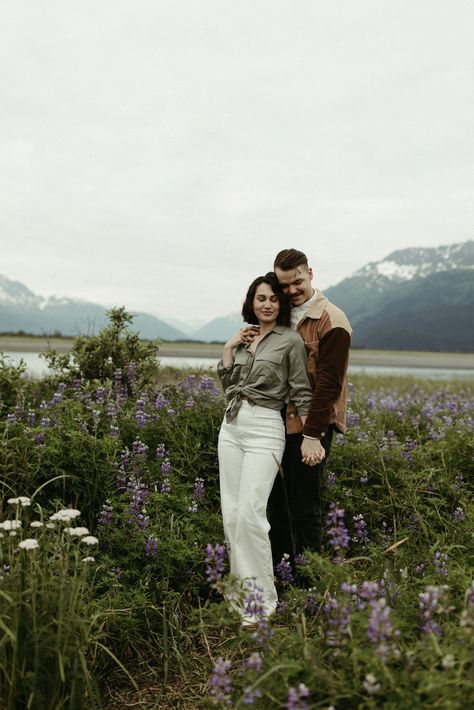 These engagement pictures in Alaska had an editorial twist. Pnw Wildflowers, Lupine Field, Outdoor Editorial, Mountain Engagement Pictures, Girdwood Alaska, Field Engagement Photos, Mountain Engagement Photos, Mountain Engagement Session, Romantic Engagement Photos