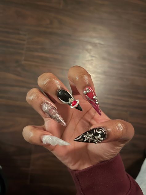 Black red silver and white stiletto nails with 3D designs Red Stilletos Nails, Red And Black Stiletto Nails, Red Stiletto Nails, Black Stiletto Nails, Red Gel Nails, Y2k Nails, Long Acrylic, Metallic Nails, Nail Charms