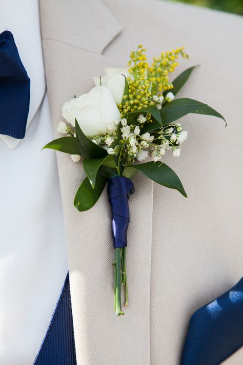 White Spray Roses, a touch of yellow Solidago and Baby's Breath wrapped with navy blue ribbon create a boutonniere a little out of the ordinary.  Photo Courtesy of Flybird Photography. Yellow And Blue Corsage And Boutonniere, White And Yellow Boutonniere, Yellow And Blue Boutonniere, Blue And Yellow Corsage, Corsage Wedding Men, Thanksgiving Desert, Yellow Boutonniere, Boutineer Wedding, Prom Flowers Corsage