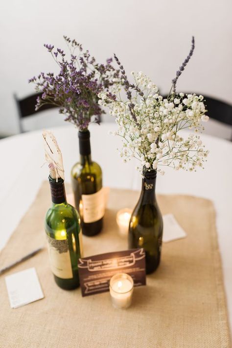 Baby's breath with lavender in wine bottles. Combine these with sheet music flowers for bouquet! Diy Centre Pieces, Wine Bottle Flowers, Cheap Wedding Table Centerpieces, Wedding Table Toppers, Diy Lavender, Expensive Flowers, Wine Bottle Centerpieces, Bottle Centerpieces, Centerpieces Diy