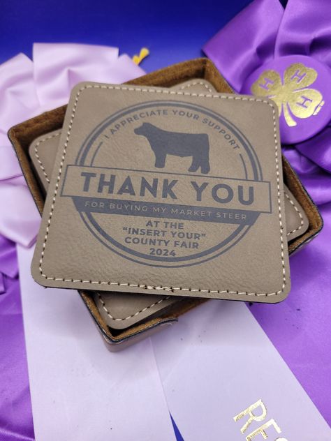 Custom Market Beef Thank You Coasters. These are the perfect gift for buyers of market steers at county fairs.  Set of 6 light brown leatherette coasters.  The set includes a matching coaster holder.   Each coaster measures 4 in x 4 in. The top of the logo says "I appreciate your support", The center has a show steer graphic.  Below the graphic, it says "Thank You", in a dark box below it says "For Buying My Market Steer" - this can be personalized. There is then space for your county, fair, or Fair Buyers Gift Ideas, Ffa Buyers Gift Ideas, Buyers Gifts 4-h, 4h Buyers Gift Ideas, Show Steers, Manhattan Ks, Show Cattle, Coaster Holder, Spring Valley