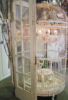 Blossoms Vintage Chic Big bird cage with chandlier in it. Love it! Big Bird Cage, Bird Cage Candle, Birdcage Chandelier, Antique Bird Cages, Large Bird Cages, Decoration Shabby, Bird Cage Decor, Vintage Bird Cage, Bird Houses Diy