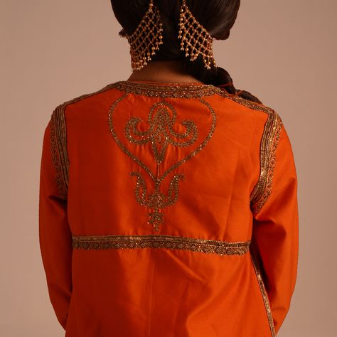 This exquisite ensemble comprises an iconic Narangi Angrakha Anarkali, featuring heavy zardozi work in antique gold that seamlessly blends with copper-colored metal thread. Paired with an intricately hand-embroidered long Mughal-style chic jacket, adding sophistication and elegance. Completed with a classic long dupatta featuring a beautiful paisley zardozi border, enhancing the ensemble's regal appeal. Overall, it represents a fusion of traditional and contemporary styles, perfect for any fo... Zardozi Border, Angrakha Anarkali, Cotton Saree Blouse Designs, Cotton Saree Blouse, Zardozi Work, Chic Jacket, Saree Blouse Designs, Copper Color, Style Chic