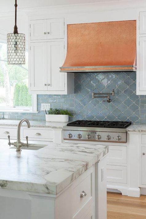 White and blue kitchen features white shaker cabinets paired with Pental Quartz Tobacco countertops and a blue subway tiled backsplash. Green Cabinets Blue Backsplash, Slate Blue Backsplash, Kitchen With Blue Backsplash, Blue Subway Tile Kitchen Backsplash, Blue Backsplash With White Cabinets, Blue Kitchen Backsplash Ideas, Trendy Kitchen Tile, Blue Subway Tile, Ceramic Tile Backsplash