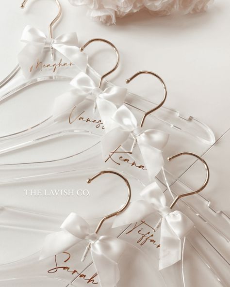 ✨ Stunning clear acrylic hangers, perfect for your wedding day! Whether you want to personalize them with a name, initials, title, or wedding date, or leave them blank, they look absolutely gorgeous either way! Each hanger comes with a complimentary ribbon to add that extra touch of pretty 🎀. These hangers are perfect for hanging your wedding dress and bridal party dresses! Imagine how amazing your dress will look in your wedding photos, hanging beautifully on one of these chic acrylic hang... Acrylic Hangers, Pearl Hanger, Bridesmaid Hanger, Bridal Party Hangers, Cricut Business, Bridesmaid Hangers, Proposal Boxes, Dress Hanger, Bridesmaid Pearls