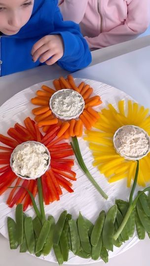 588K views · 17K reactions | EASY FLOWER CRUDITE PLATTER!!🌼🌸 SAVE & SHARE this adorable veggie platter idea!! Perfect for spring and summer parties and mothers or Easter Day!!

LIKE + COMMENT “flower” - I will send you all the details and full recipe! This is so easy to make and adorable for all your parties! Only way I will be serving veggies this summer!

FOLLOW ME @athomewith.shannon for more easy recipes and fun ideas!! #charcuterie #charcuterieboard #veggie #veggieplatter #easyrecipeideas #easyrecipe #momhack | Shannon Doherty | Wuki · Sunshine (My Girl) Flower Shaped Veggie Tray, Veggie Flower Charcuterie, Sunflower Vegetable Tray, Charcuterie Board Ideas For Mother’s Day, Sunflower Fruit Platter, Sunflower Veggie Tray, Princess Veggie Tray Ideas, Veggie Flowers Food Art, Flower Themed Party Food