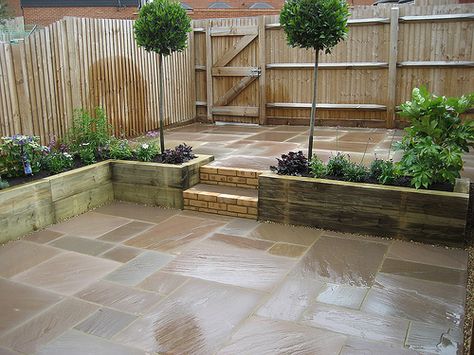 small courtyard garden for entertaining and easy plant maintenance, raised sleeper planting beds, Indian Sandstone paving Small Garden Grass And Paving, Small Two Level Garden Ideas, Small Paved Back Garden Ideas, Garden Slabbing Ideas, Indian Sandstone Patio With Sleepers, Paved Garden With Raised Beds, Small Raised Patio Ideas, Wooden Sleepers Garden, Paved Courtyard Ideas