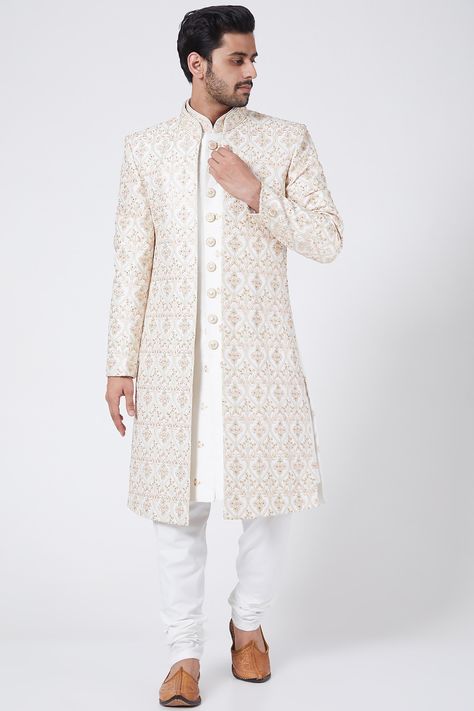 Featuring a white open jacket in raw silk base with thread, sequins, and zari embroidery. It is paired with contrasting churidar pants in cotton silk base and sherwani having a mandarin collar.    FIT: True to size.  COMPOSITION: Raw silk, Cotton silk.  CARE: Dry clean only. Weeding Outfits For Boys, Machine Work Embroidery, Wedding Dress For Boys, Embroidery Dress Designs, Open Sherwani, Indo Western Outfits For Men, Wedding Matching Outfits, Man Dress Design, Indian Wedding Clothes For Men