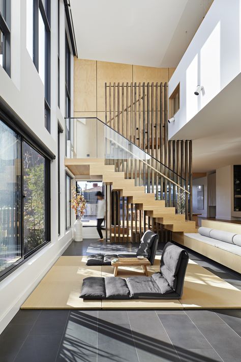 A stair with freestanding cross laminated timber balustrade becomes the design feature of this sunny double-volume living area in a Melbourne house. (design by Urbourne Architecture, photo by Tatjana Plitt) Contemporary Long House, Double Volume Stairs, Double Volume House, Double Volume Staircase, Freestanding Staircase, Double Volume Space, Open Staircases, Timber Balustrade, Stair Design Ideas