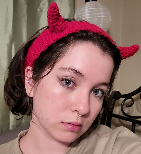 Girl with short brown hair, piercings, and blue eyes wearing a red headband with small red devil horns. Crochet Horns Headband, Crochet Horn Headband, Devil Crochet Pattern Free, Free Balaclava Pattern, Crochet Devil Horns Free Pattern, Crochet Headband Ideas, Crochet Horns Free Pattern, Crochet Devil Horns, Diy Devil Horns