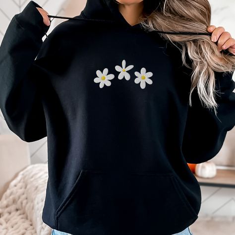 Embroidered Daisies Hoodie, Embroidered Daisy Flowers Hoodie, Daisies Embroidered Shirt, Cute Embroidered Hoodie, Daisy Sweatshirt This embroidered daisies hoodie is everything. Perfect to wear on a lazy day or when you just want to feel cozy. ✨ 50% cotton, 50% polyester ✨ Pre-shrunk ✨ Super soft feel and reduced pilling ✨ Double-lined hood with matching drawcord Care: Machine wash: warm (max 40C or 105F) Tumble dry: low Do not iron directly on the embroidery REFUNDS AND EXCHANGES All items are made to order using multiple suppliers to ensure quick worldwide shipping. For this reason we are unable to accept returns/exchanges unless there's a defect in the item you've received. Thank you so much for shopping! Please send me a message if you have any questions, concerns or custom requests. Embroidery On Hoodies, Daisy Sweatshirt, Embroidered Daisies, Hoodie Embroidery, Embroidery Hoodie, Casual Wear Women, Daisy Flowers, Lazy Day, Embroidered Hoodie