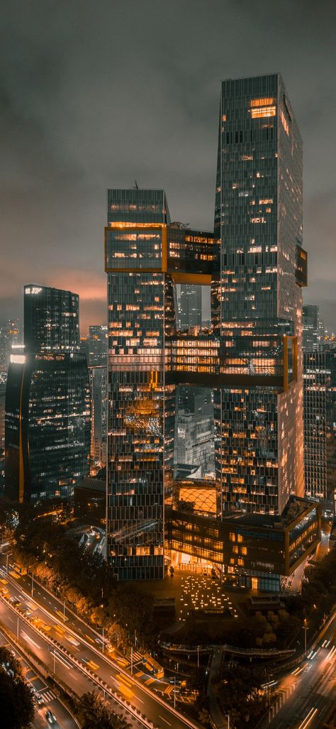 Image of a skyscraper at night surrounded by lights Skyscraper Wallpaper, Skyscrapers At Night, Wallpaper Dark, Dark Wallpaper, At Night, New York Skyline, Skyscraper, Multi Story Building, Building