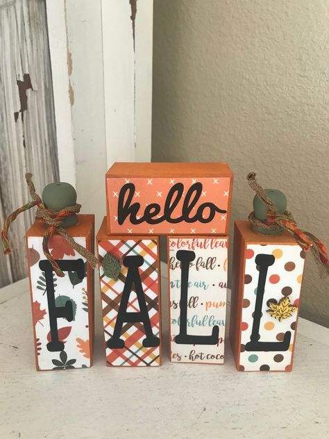 Love this, can be used on tier tray but probably fit a shelf better. 4 and 5 inches high. The hello block is 3 long. Painted added coordinating prints to front, vinyl and two tiny wooden leaves. Stems added to two and fall colored jute. Thanks for stopping by. If you are purchasing multiple items I am happy to set up a custom listing to save you on shipping. Please note that farmhouse decor is not perfect, there are sometimes flaws in the wood and such that add to the rustic look. If for any rea Painted Blocks Of Wood, Fall Wood Crafts Diy Wooden Blocks, Diy Wood Blocks Decor, Fall Wood Blocks, Fall Blocks Wood Crafts, Wooden Tray Ideas, Wooden Blocks Decor Craft Ideas, Pumpkin Mantle, Fall Tier Tray Decor