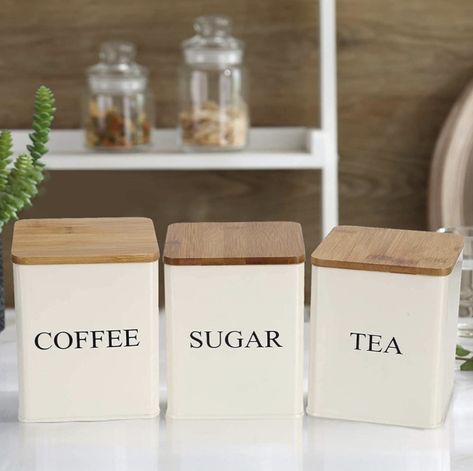 Made of durable and food-grade stainless steel, natural bamboo lids create an extra tight seal. Each measures 5.5 x 4 x 4 inches (14.1 x11 x 11cm), protect your kitchen essentials and keep them close on hand on the counter, in the pantry, or in the cabinet. Volume: 1.5 litres Includes 3 beige canisters with Coffee, Sugar, and Tea writing prints on the exterior. Features air tight bamboo lids so the air stays out and your food stays fresh! These are highly durable, long-lasting and have enough d Metal Storage Containers, Sugar Container, Kitchen Canister Set, Coffee Canister, Kitchen Containers, Tea Storage, Kitchen Food Storage, Metal Kitchen, Kitchen Canisters