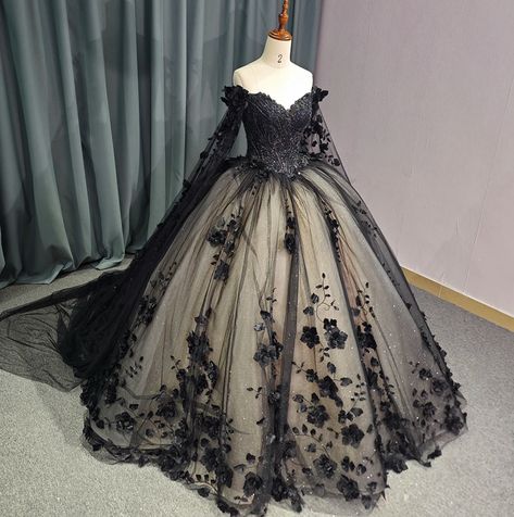 Timeless vintage-inspired Black Sweetheart Quinceanera Dress. Featuring an intricate beadwork bodice, off-the-shoulder long sleeves with a dramatic floral drape shoulder cape, this dress exudes glamour and luxury. The black lace overlay complete with hand sewn florals adds a touch of elegance, while the adjustable lace-up back ensures a perfect fit. Elevate your party look with this exquisite ball gown. material: glitter tulle, organza type: ball gown style: formals color as shown built in bra s Bell Sleeve Ball Gown, Lace Colored Wedding Dress, Black Poofy Wedding Dress, Dark Blue And Black Quinceanera Dresses, Black Quinceanera Dresses With Sleeves, Black Princess Dress Fairytale, Princess Wedding Dresses Black, Black And White Quinceanera Dresses, Goth Quinceanera