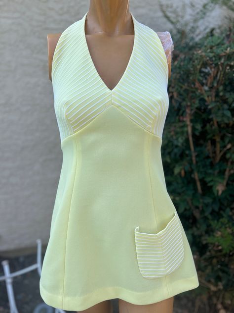 Here is a vintage 1970s yellow Polyester halter Tennis Dress.Made by Top Seed. Following are the measurements. Bust 32",Waist 28",Hips 40",Length measured from top of halter strap to hem 32".Zips up the back.The bodice is a yellow striped fabric.Rest of the dress is solid yellow.In nice vintage condition. Please take special consideration of measurements. 1970 sizing was much smaller than today's standards. Take extra special note of length. Tennis dresss were very short not like a regular dress Vintage Tennis Dress, 1970s Summer Fashion, 60s Outfits, 70s Inspired Fashion, Vintage Tennis, Womens Sports, Halter Strap, Striped Fabric, Tennis Dress