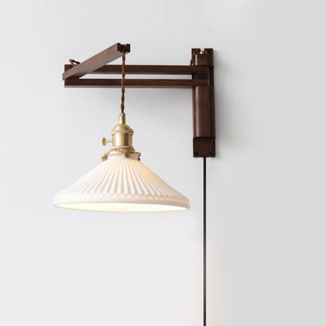 Transform your space into a peaceful oasis with our Japanese Retro Walnut Folding Wall Lamp. The elegant walnut base adds a touch of sophistication, while the foldable and rotatable design allows for the perfect angle and ambiance. Experience the calming vibes of retro Japanese style in any room. • Metal, Wood, Ceramic • Wall Lamp • 5W • 90-260V • Knob Switch • E27 LED Bulbs • Shade Size : 9"x6"(23x16 cm) Mid Century Modern Eclectic, Tapestry Hanger, Foldable Wall, Wall Pendant, Retro Desk, Retro Japanese, Folding Walls, Wood Ceramic, Contemporary Mid Century Modern